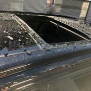 The shattered sunroof of a car parked in Market Street which was attacked by vandals