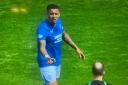 James Tavernier hands the missiles to referee Willie Collum
