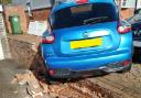 The parked car was pushed over a neighbour's wall.