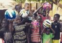 Distributing footballs at Kutosilo village. Photo: Project Gambia