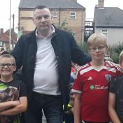 Lye trader Gary Farmer at the community gathering with Alfie, Liam and Nathan Jackson