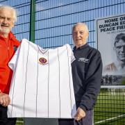 Legendary Aston Villa captain Dennis Mortimer presented league chairman John Farley with a replica of the club’s European Cup winning shirt, which will be signed and auctioned to raise funds for the peace field project. Pic - Jonathan Hipkiss