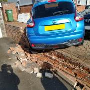The parked car was pushed over a neighbour's wall.