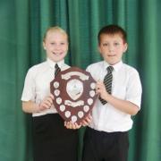Inspirational youngsters: St Oswald’s Primary School students Lucy Williams, 11 and Jordan Joslin, 10, hold the young citizen’s challenge shield.