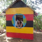 At play: Esther Gittoes with Busoona students in the playhouse she helped to build.