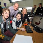 Alan O'Donohoe, from Jam Packed, and Stourbridge MP Margot James, with Alex Turner, 15, and Casey Childs, 11, at the Pedmore Technology College hosted computing festival. Photo: Nick Toogood