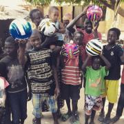 Distributing footballs at Kutosilo village. Photo: Project Gambia