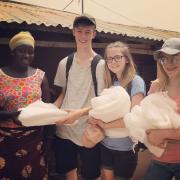 Handing out mosquito nets at Kutosilo village. Photo: Project Gambia