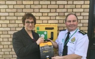 College principal Remley Mann and Andy Jeynes, of West Midlands Ambulance Service, with the newly installed defibrillator. Photo: King Edward VI College