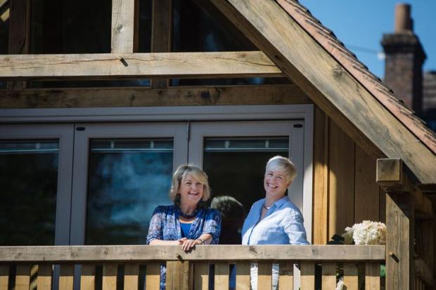 Stourbridge News: Little Lodge owner Samantha Parr (left) and architect Andrea Millner on the balcony of the award-winning house. Pic by Lyndon Darkes 