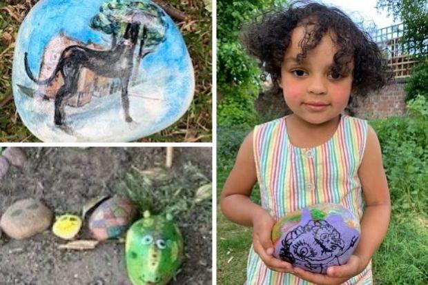 Peony Dorival, three, with a stone left by her friend Lilah Duffy, four, for her to find...George the rock snake under construction and one of the pretty stones left in the park