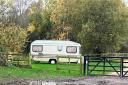 The caravan where a man had been living on canalside parkland by Stourbridge Canal for about a year