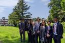 The Eco Committee leaders in front of their wildflower meadow: From left to right: Tony G, Rosie T, Grace D, Felix K, Chelsey D, Matt W and Umar S