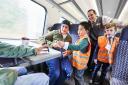 Adam Shaikh, aged six, from Stourbridge, centre, as a train conductor for the day