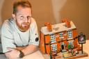 Chris Weaver with his Lego Crooked House. Pic - Emma Trimble/SWNS