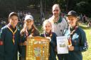 Wollescote Scout Troop members Samuel Bridgewater, 11, Sharna Stevens, 12, Jessica Dimmock, 10, and Lucy Skidmore, 12, being presented with the Jaquiss Shield at Kinver Campsite by Howley Grange Scout leader Richard Morris. Photo: Halesowen and District
