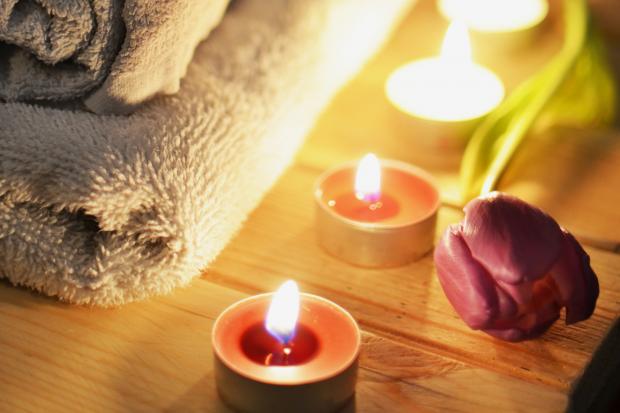 Stourbridge News: A pile of towels, candles and a tulip. Credit: Canva