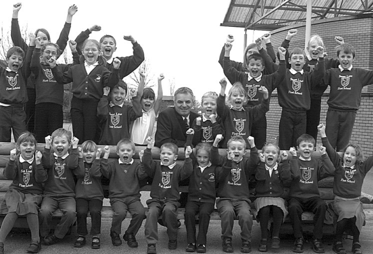 Headteacher Graham Walker and pupils at Swan Lane First School celebrate their Ofsted ‘outstanding’ report in January 2004