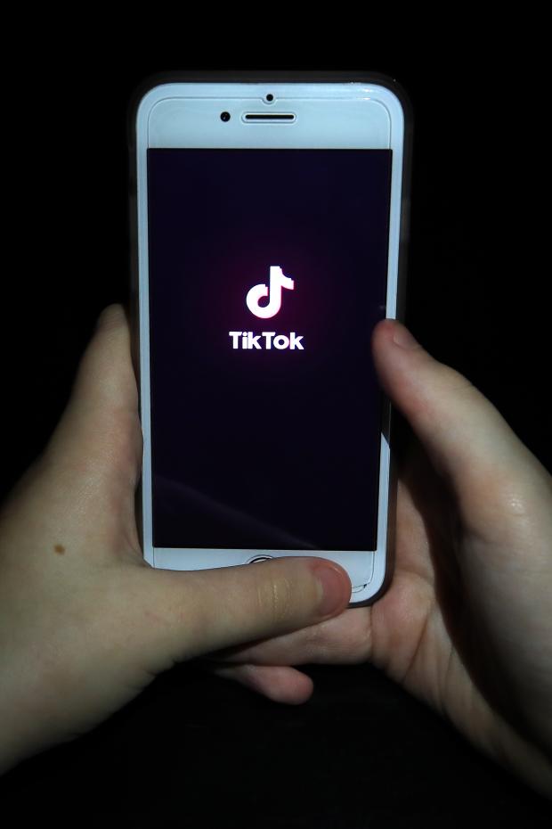 Stourbridge News: A person with TikTok open on their phone. Credit: PA