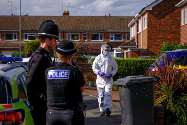 Police at the scene on Cairndhu Drive in Kidderminster last August. Photo: SWNS
