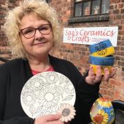 Carly Grandini-Williams of Saz's Ceramics & Crafts, with items from the Ukraine pottery range