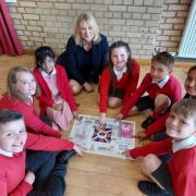 Suzanne Webb MP with Amblecote Primary School students and their winning designs from the MP's A Card for the Queen Platinum Jubilee competition