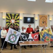A commemorative flag exchange ceremony held in Fort William  in 2023 as part of the annual pilgrimage in memory of Bert Bissell.  Alderman Steve Waltho, pictured centre, holding the Black Country flag