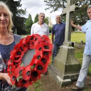 Friends of Lye and Wollescote Cemetery members Sue Smith, Jim Dunn, Colin James and Rob Skelding with the commemorative wreath next to Lieutenant Turner’s grave