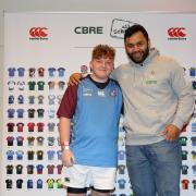 Crestwood School pupil Lewis Brett unveiled his school’s new rugby kit at the England v Italy 6 Nations tie at Twickenham, alongside England international Billy Vunipola. Photo: Sportsbeat