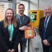 Cllr Kerry Lewis at the school with the new life-saving piece of kit, with Paul Grove (of FastAid Black Country) and headteacher Keith Butler.